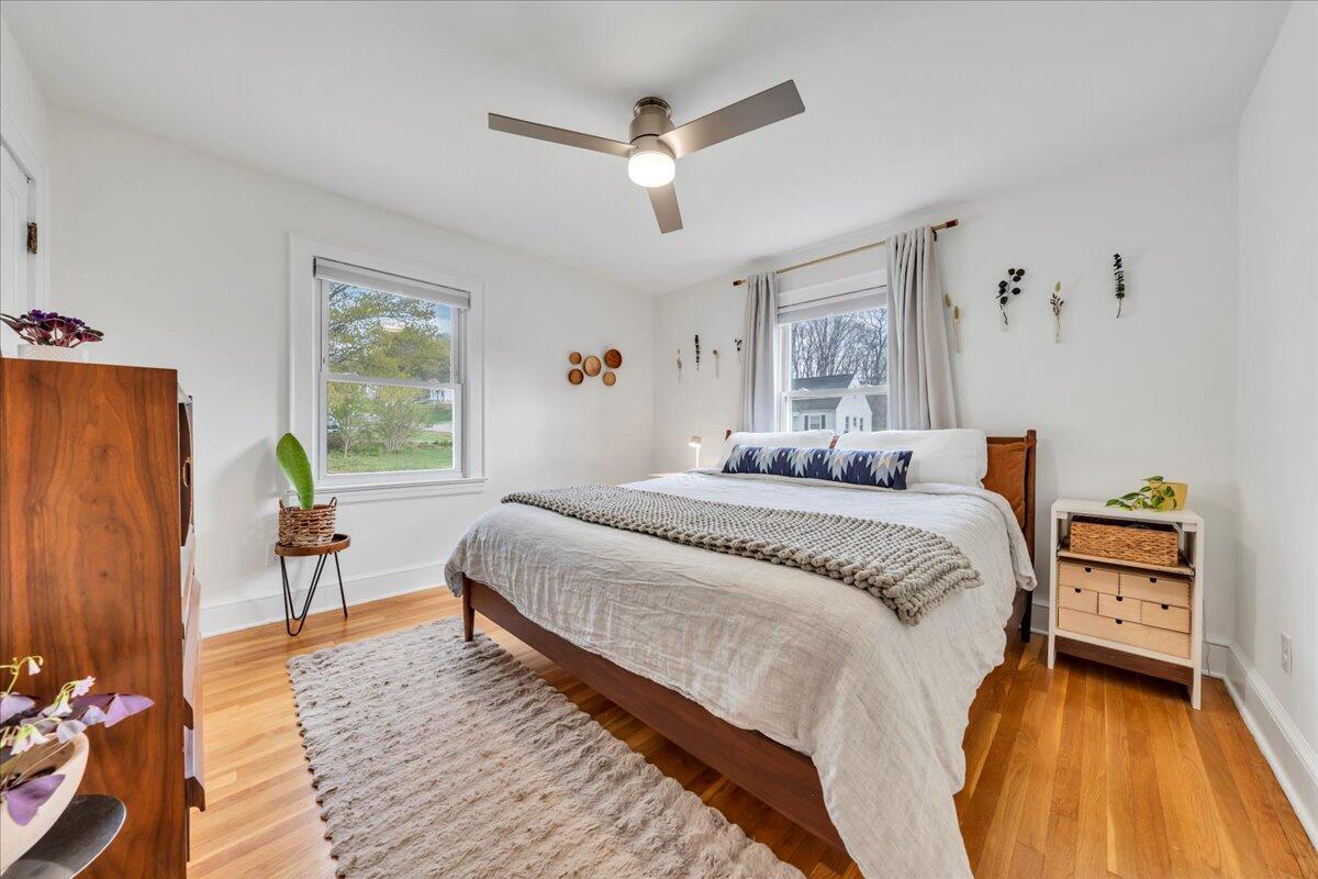 5120 Starkey Road Roanoke, VA 24018 - Photo 18 of 43 a bedroom with a bed and wooden floor