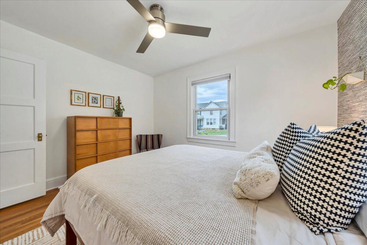 5120 Starkey Road Roanoke, VA 24018 - Photo 21 of 43 a bedroom with a bed and a dresser with wooden floor