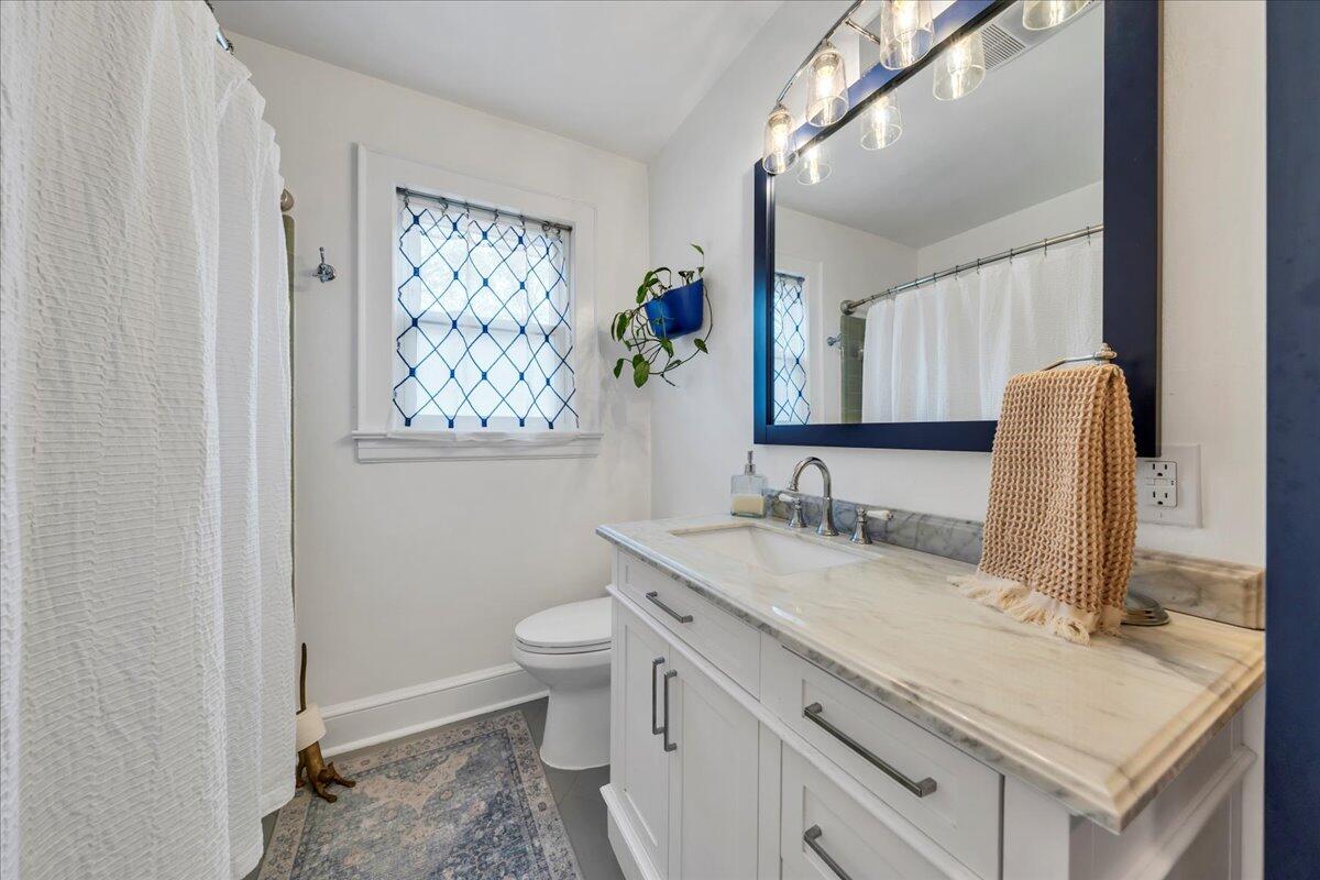 5120 Starkey Road Roanoke, VA 24018 - Photo 23 of 43 a bathroom with a granite countertop sink toilet and a mirror