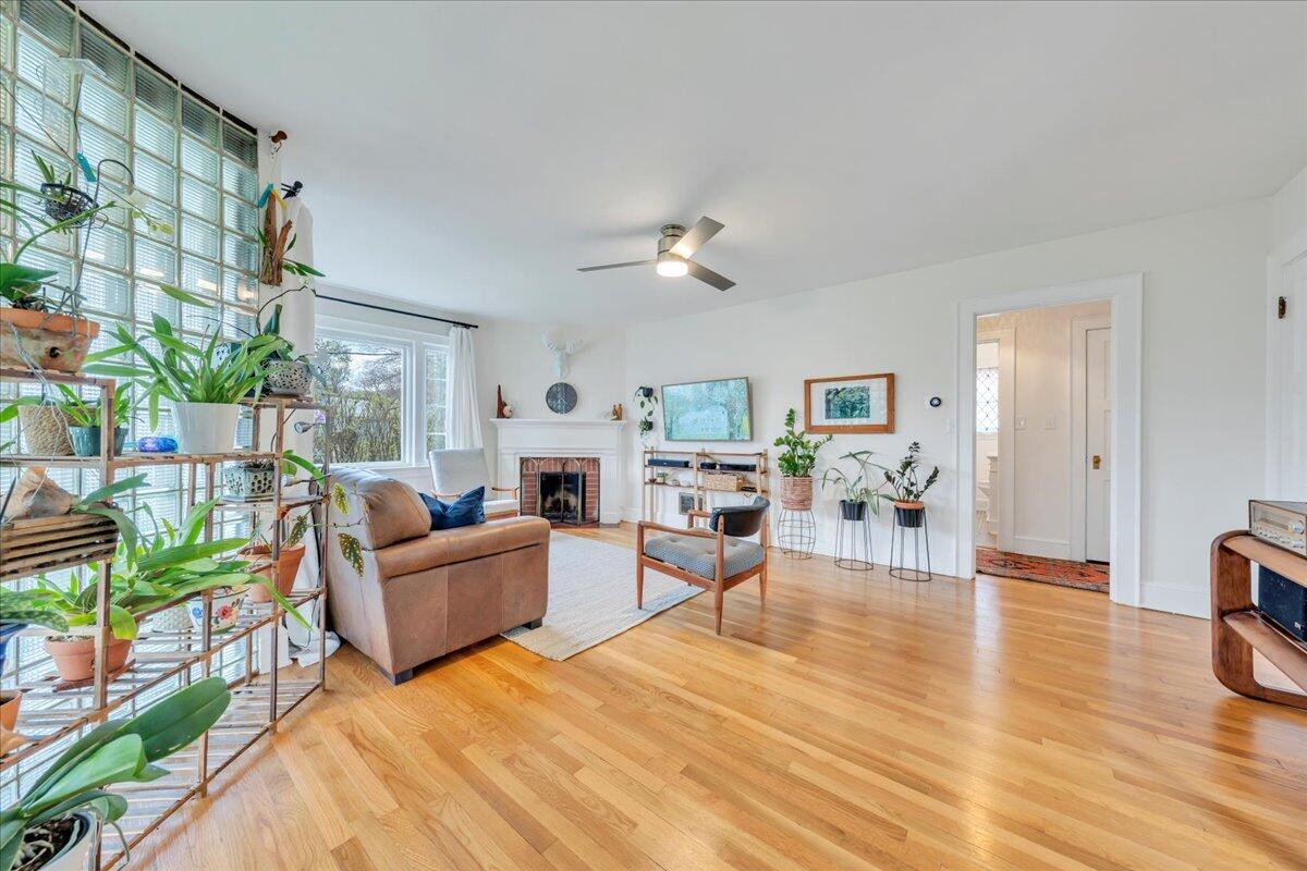 5120 Starkey Road Roanoke, VA 24018 - Photo 7 of 43 a living room with fireplace furniture and a wooden floor