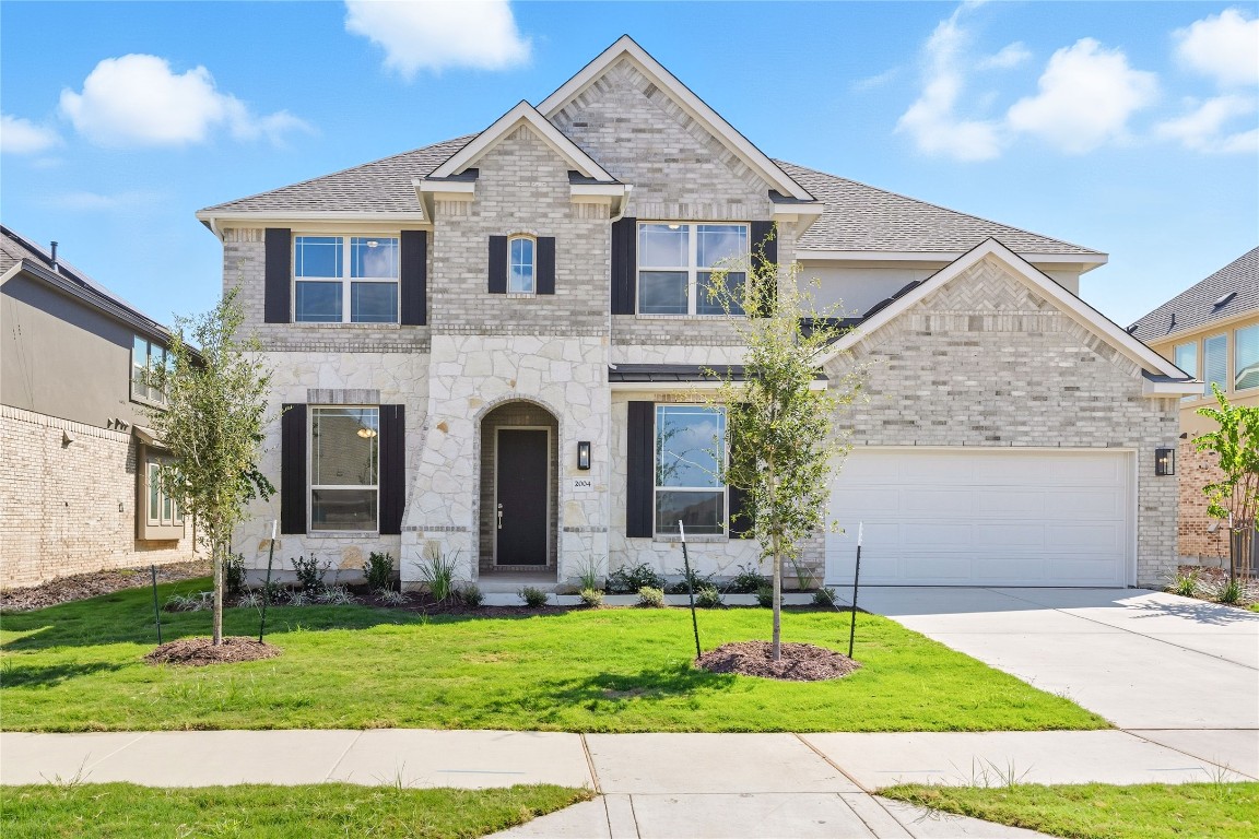 a front view of a house with a garden and plants