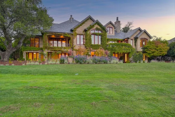 a front view of a house with a garden