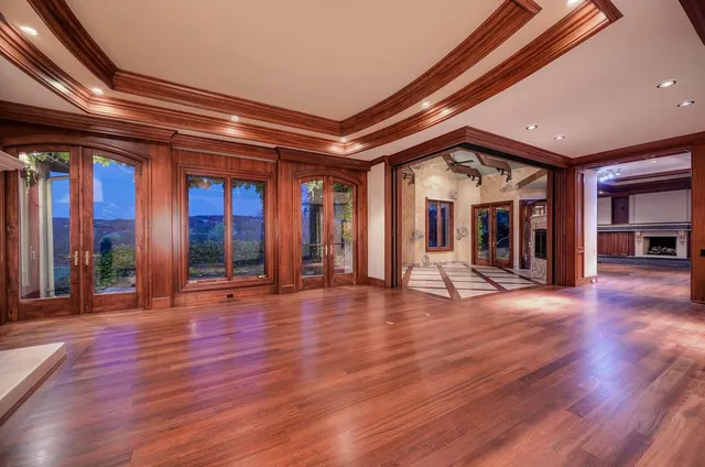 wooden floor in an empty room with a fireplace