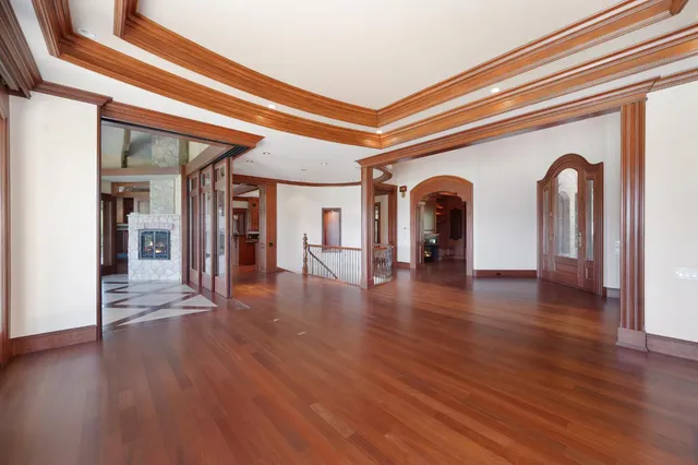 a kitchen with stainless steel appliances granite countertop a sink a stove and a wooden floors