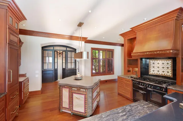 a view of a hallway with cabinet and wooden floor