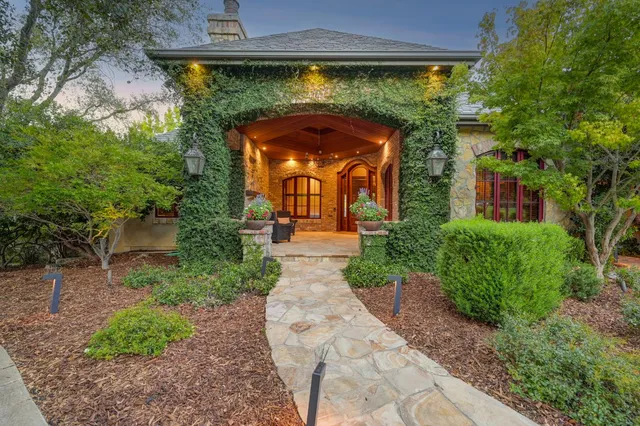 a view of a patio with couches table and chairs and potted plants