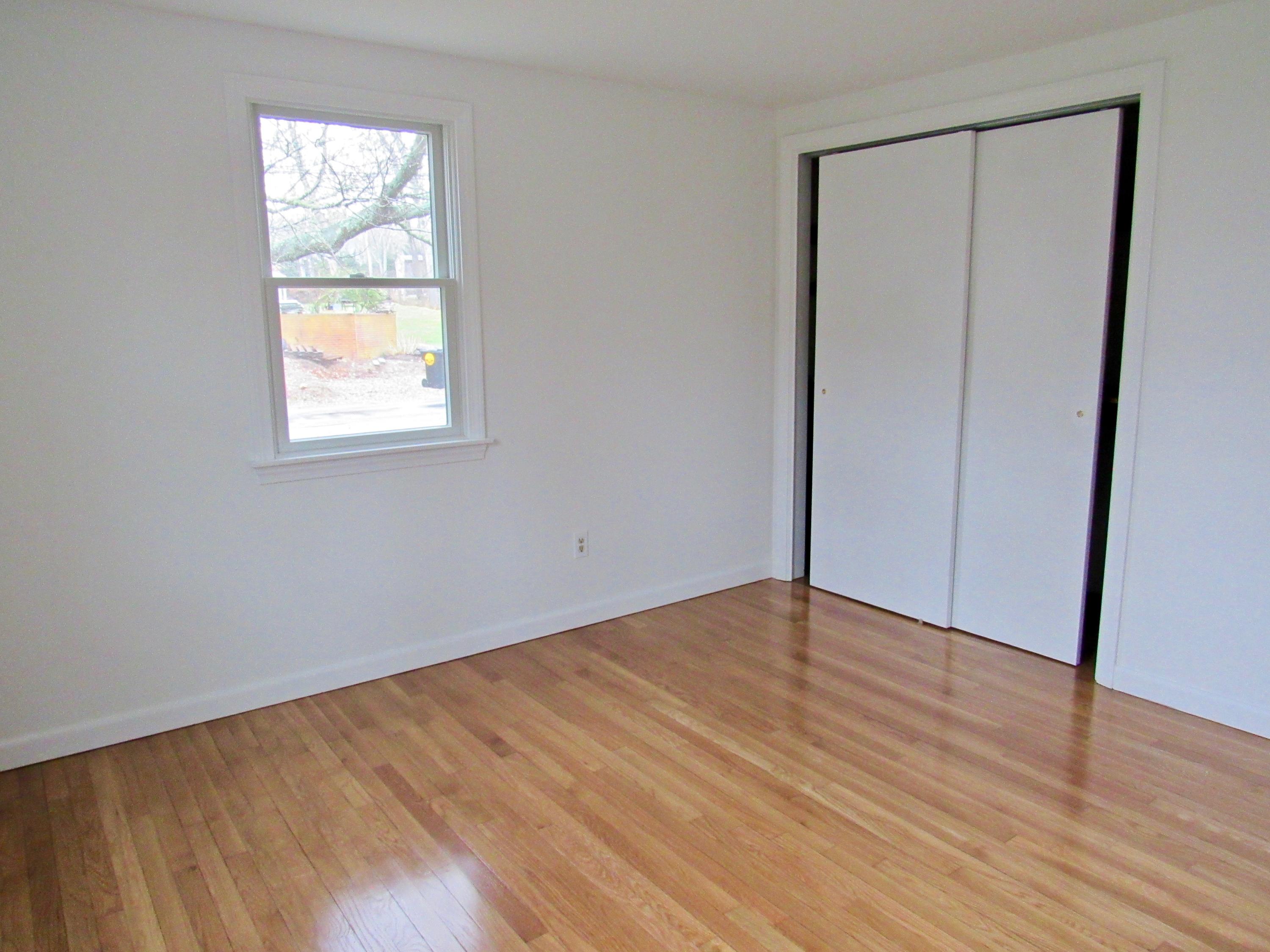 67 Long Road Harwich, MA 02645 - Photo 16 of 30 an empty room with wooden floor and windows