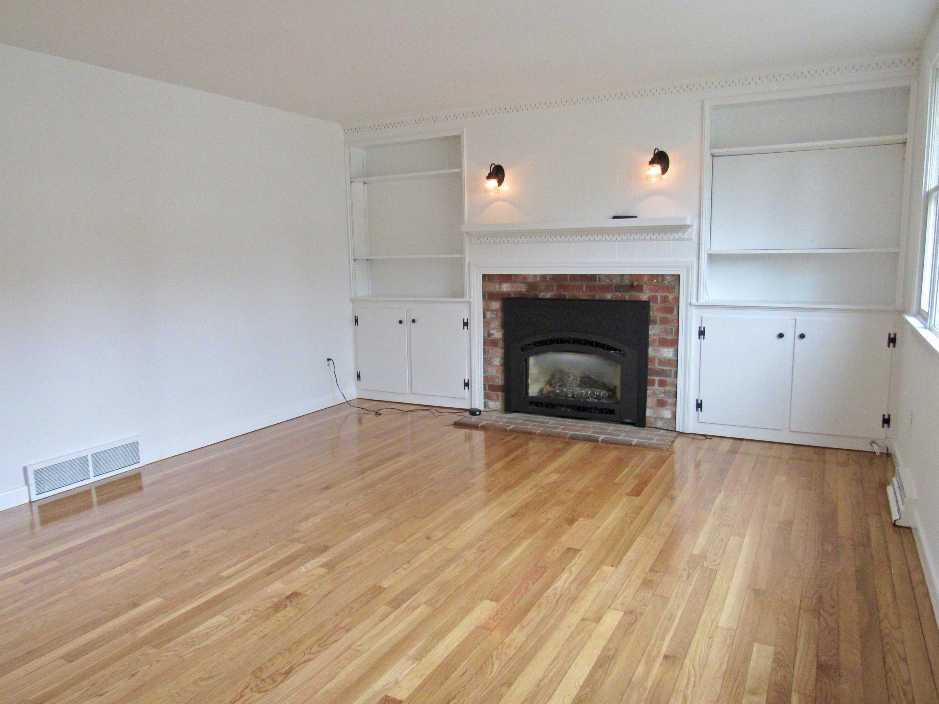 67 Long Road Harwich, MA 02645 - Photo 4 of 30 a view of empty room with wooden floor and fireplace