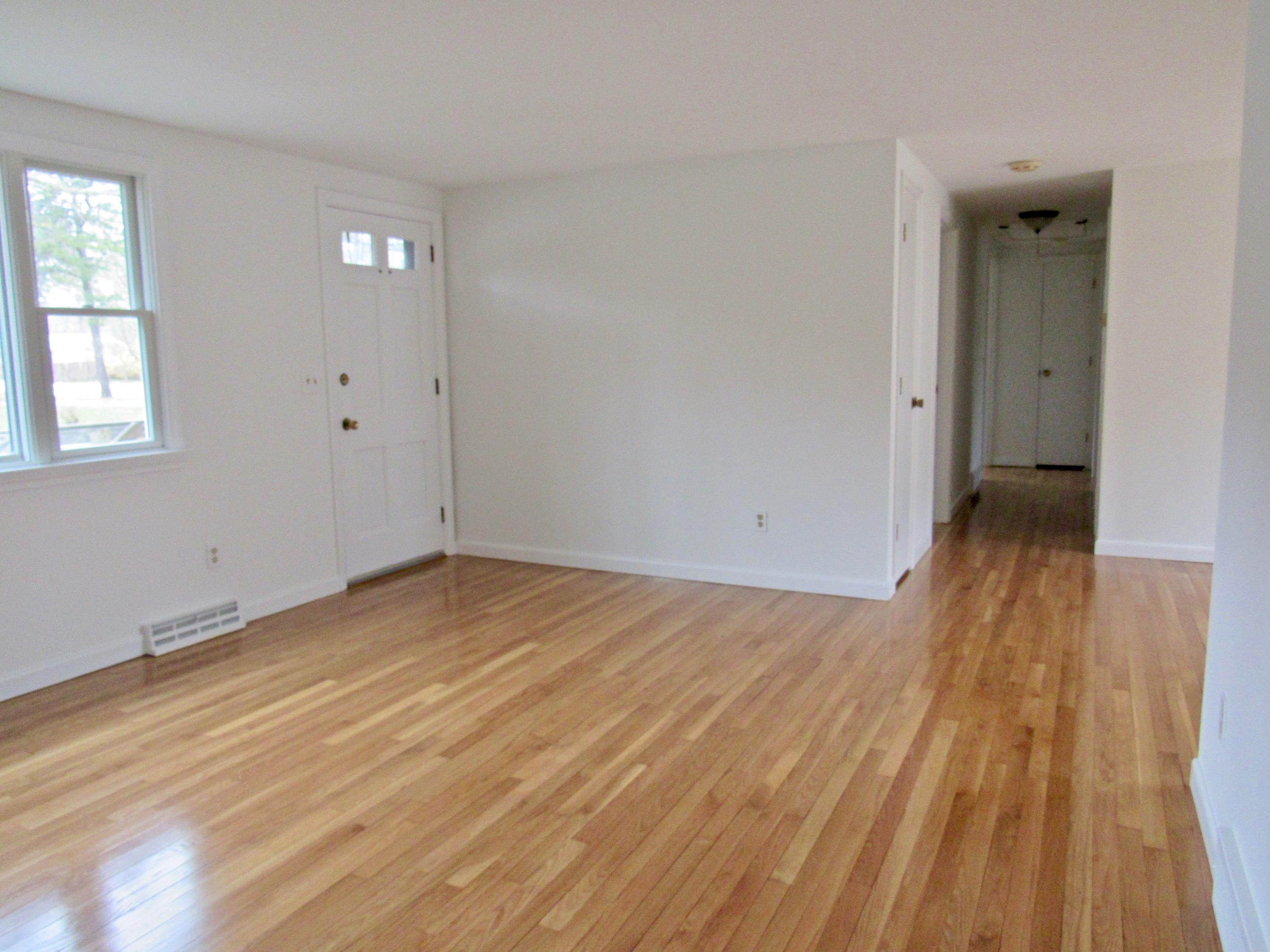 67 Long Road Harwich, MA 02645 - Photo 6 of 30 an empty room with wooden floor and windows