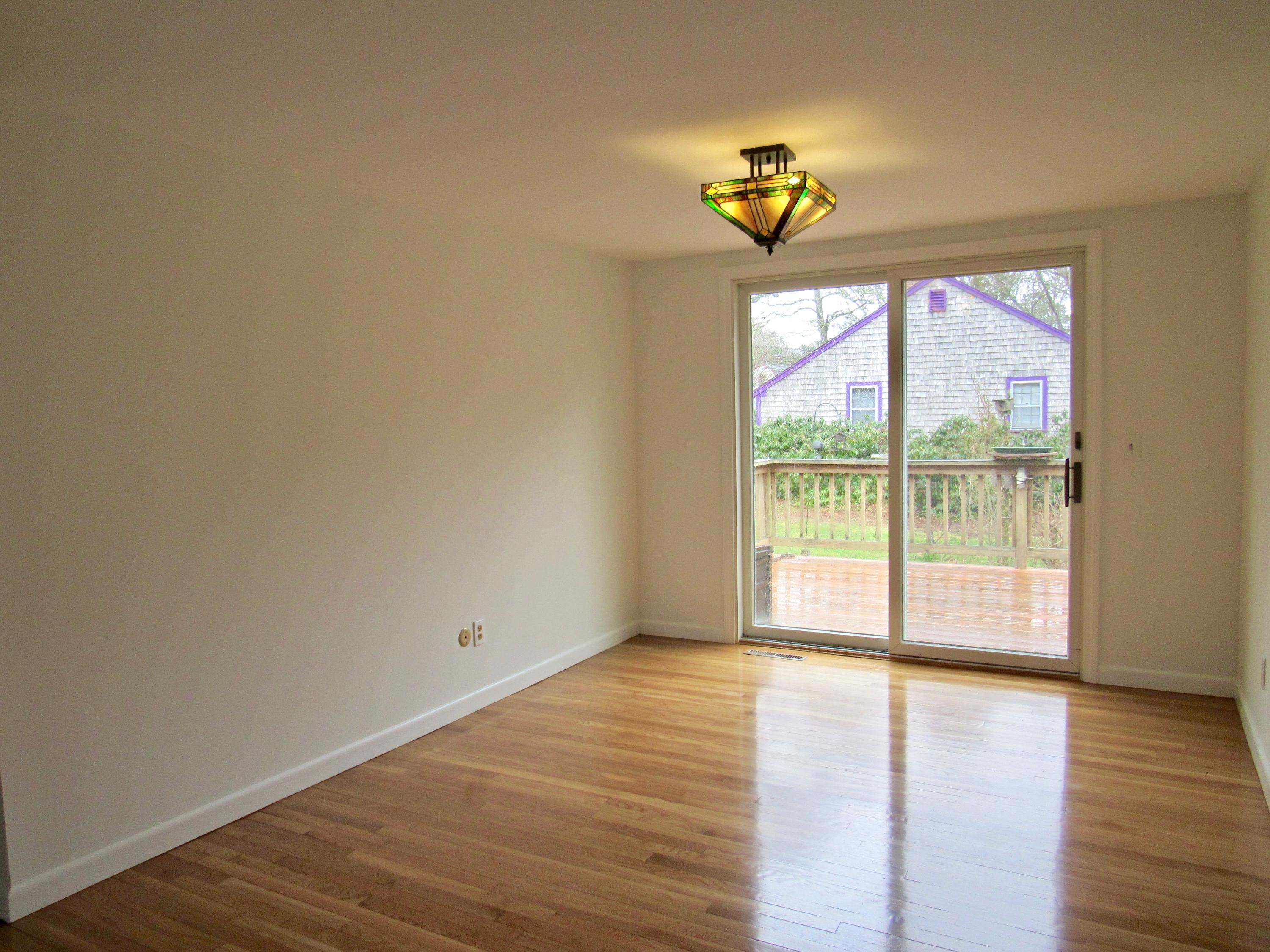 67 Long Road Harwich, MA 02645 - Photo 7 of 30 a view of empty room with wooden floor and fan