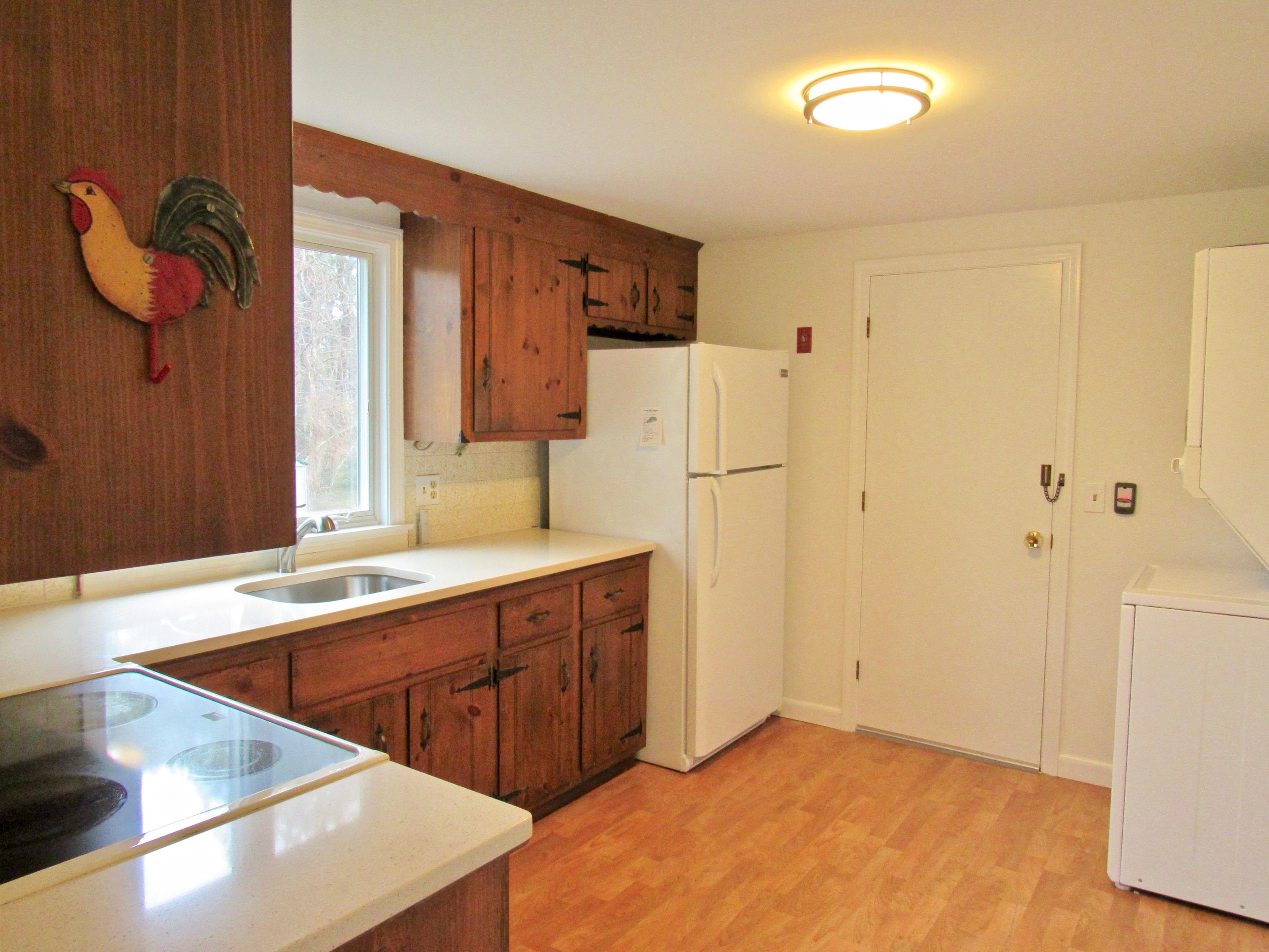 67 Long Road Harwich, MA 02645 - Photo 9 of 30 a kitchen with stainless steel appliances granite countertop a refrigerator and a sink
