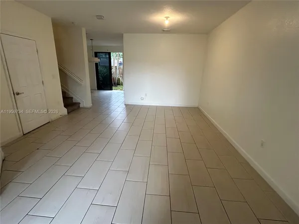 a view of a hallway with stairs