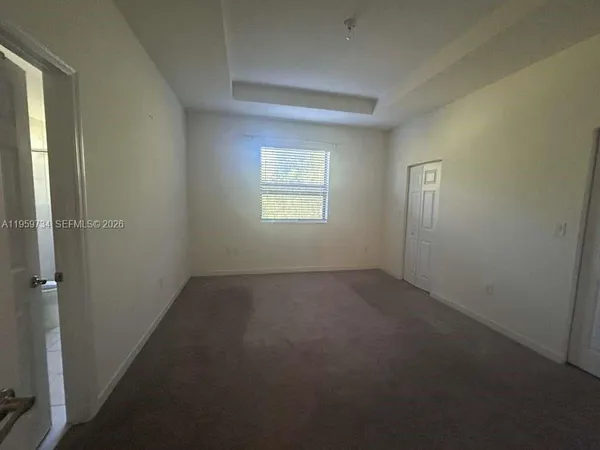an empty room that has a window in it