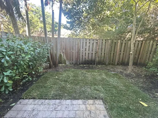 a view of garden with wooden fences