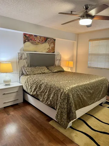 a bed sitting in a bedroom next to a lamp