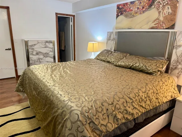 a bed sitting in a bedroom next to a cabinet