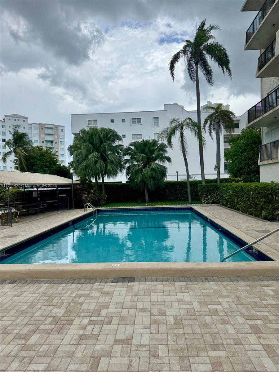 201 180th Drive, Unit 114 Sunny Isles Beach, FL 33160 - Photo 19 of 29 a view of swimming pool with chairs