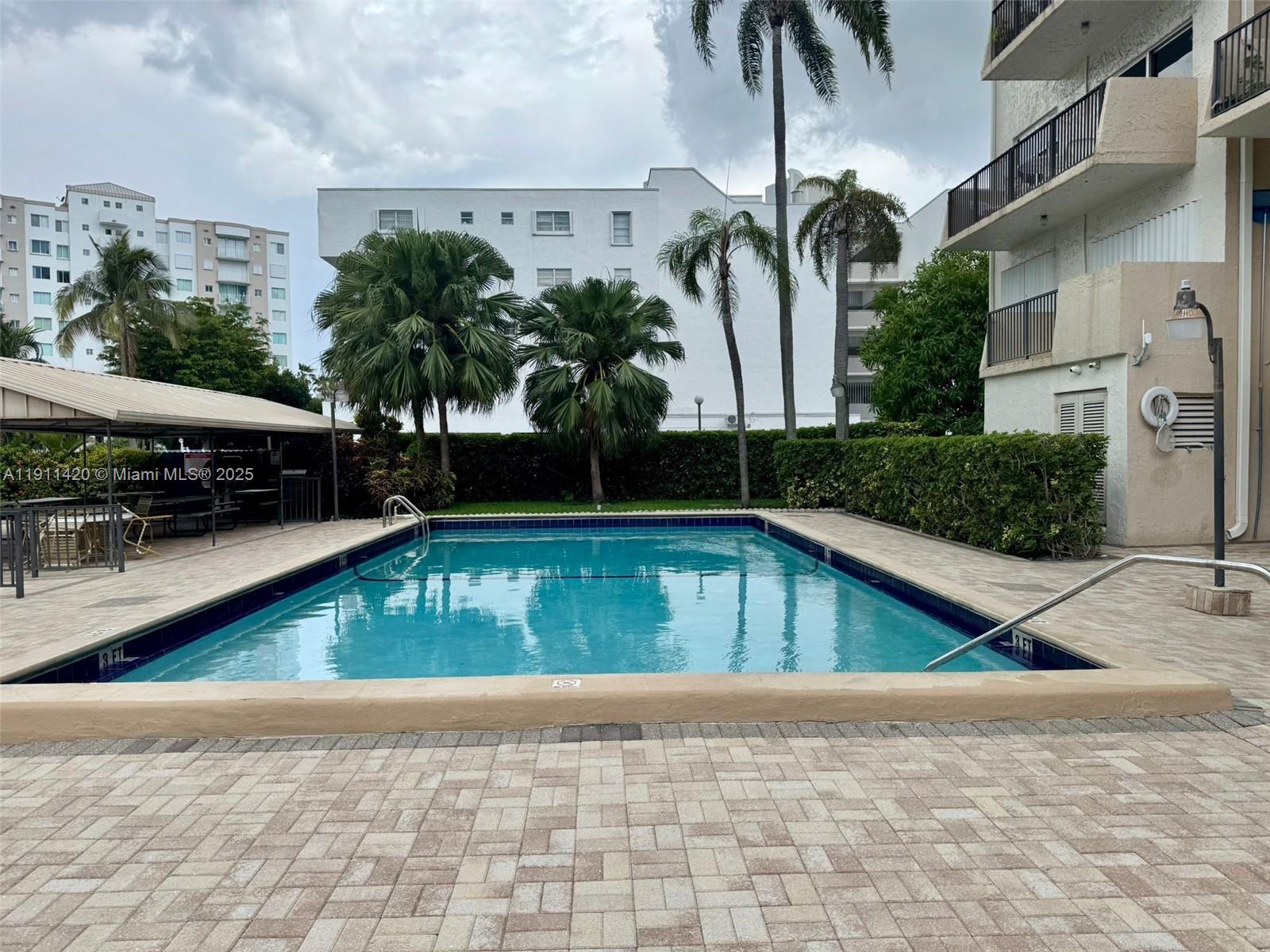201 180th Drive, Unit 114 Sunny Isles Beach, FL 33160 - Photo 20 of 29 a view of a house with a swimming pool