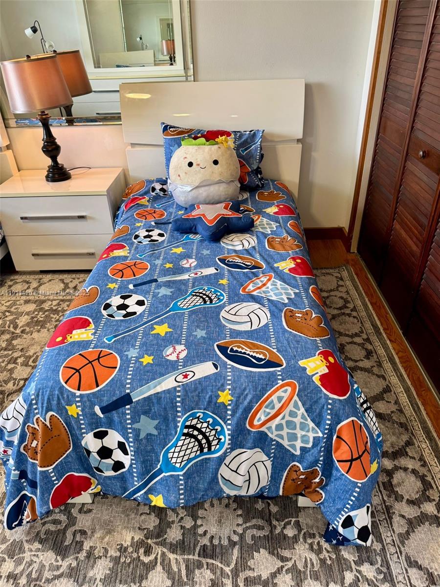 201 180th Drive, Unit 114 Sunny Isles Beach, FL 33160 - Photo 22 of 29 a room with toys and wooden floor