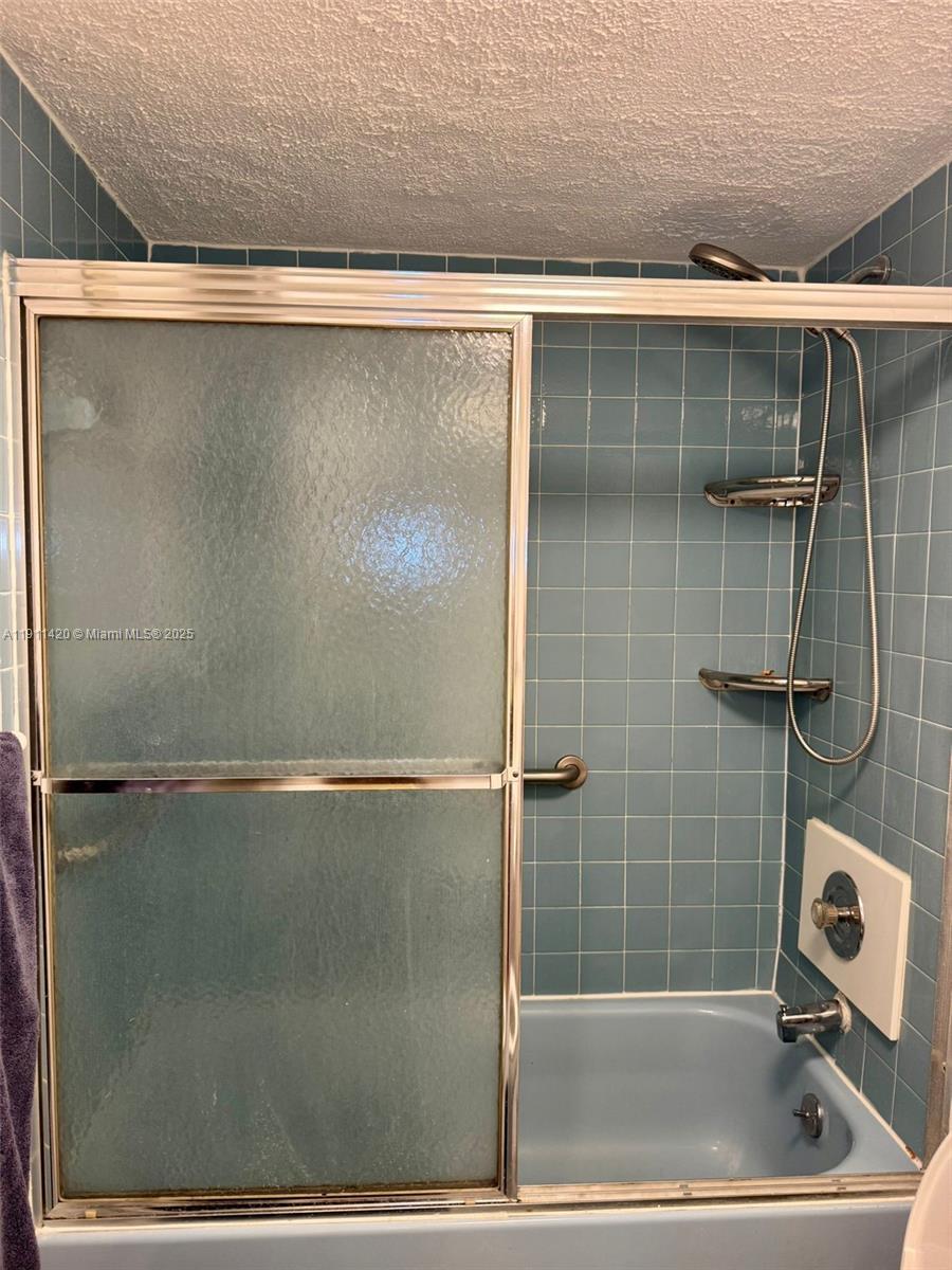 201 180th Drive, Unit 114 Sunny Isles Beach, FL 33160 - Photo 25 of 29 a bathroom with a shower