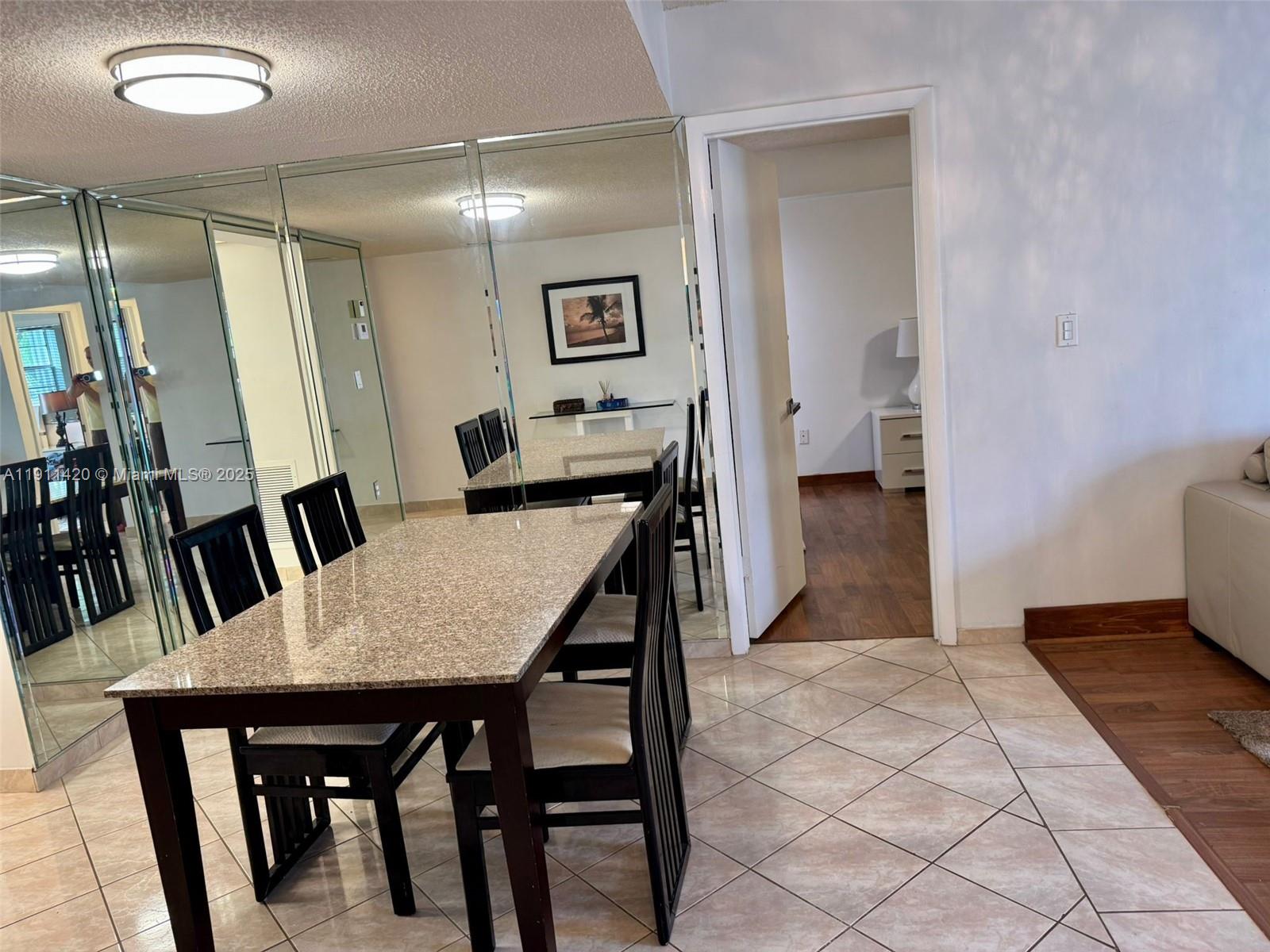 201 180th Drive, Unit 114 Sunny Isles Beach, FL 33160 - Photo 5 of 29 a view of a dining room with furniture