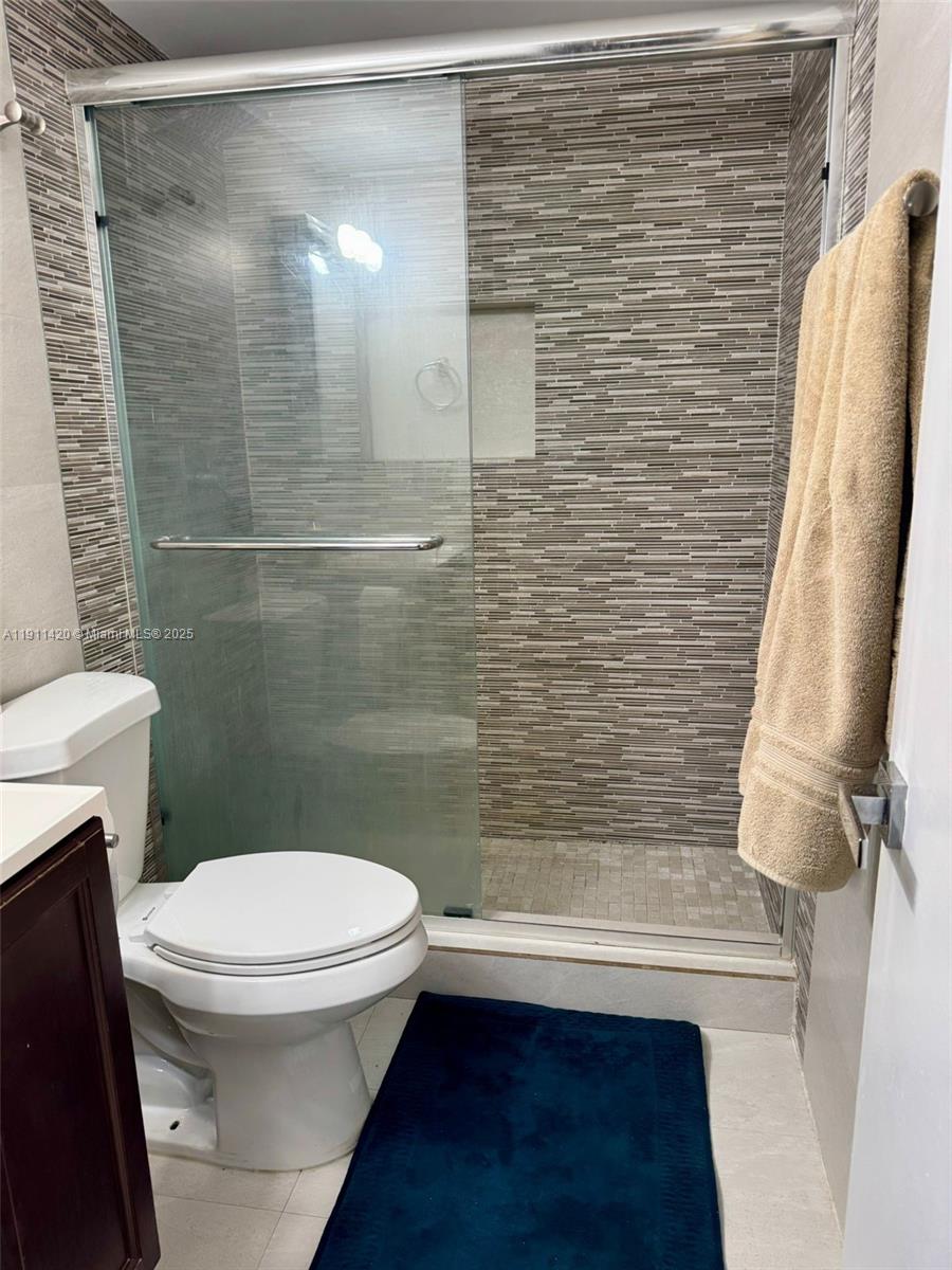 201 180th Drive, Unit 114 Sunny Isles Beach, FL 33160 - Photo 7 of 29 a bathroom with a toilet and a shower