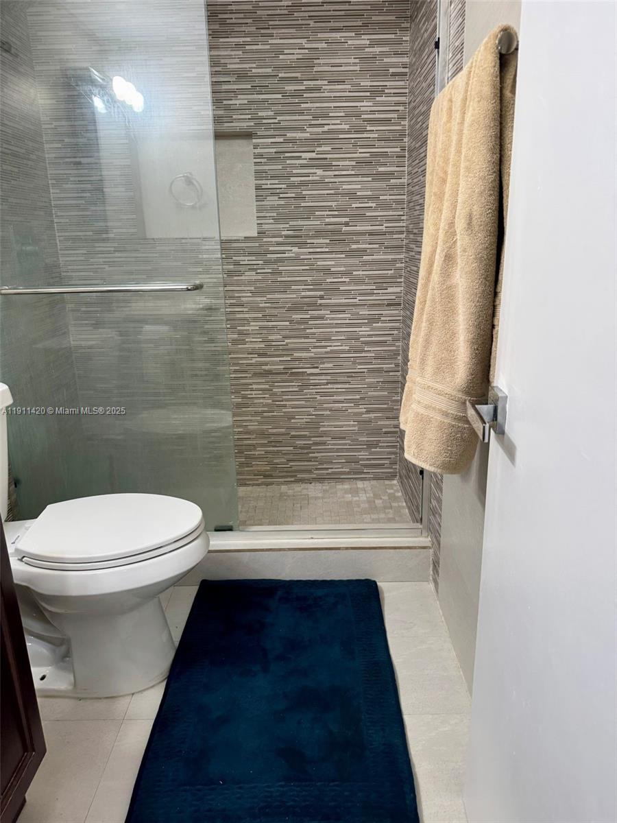 201 180th Drive, Unit 114 Sunny Isles Beach, FL 33160 - Photo 9 of 29 a bathroom with a toilet and a shower
