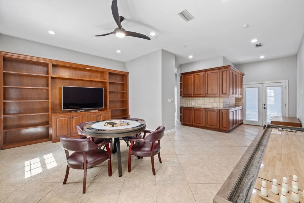 10800 Beach Road Leander, TX 78641 - Photo 14 of 39 A recreation room for lively entertainment, offering built-in storage and double French doors.