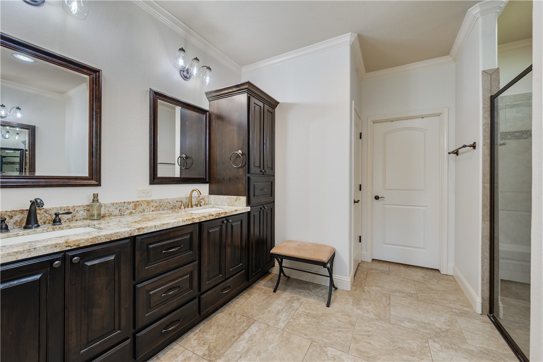 3301 Covington Court Bryan, TX 77808 - Photo 12 of 26 a spacious bathroom with a double vanity sink mirror and toilet