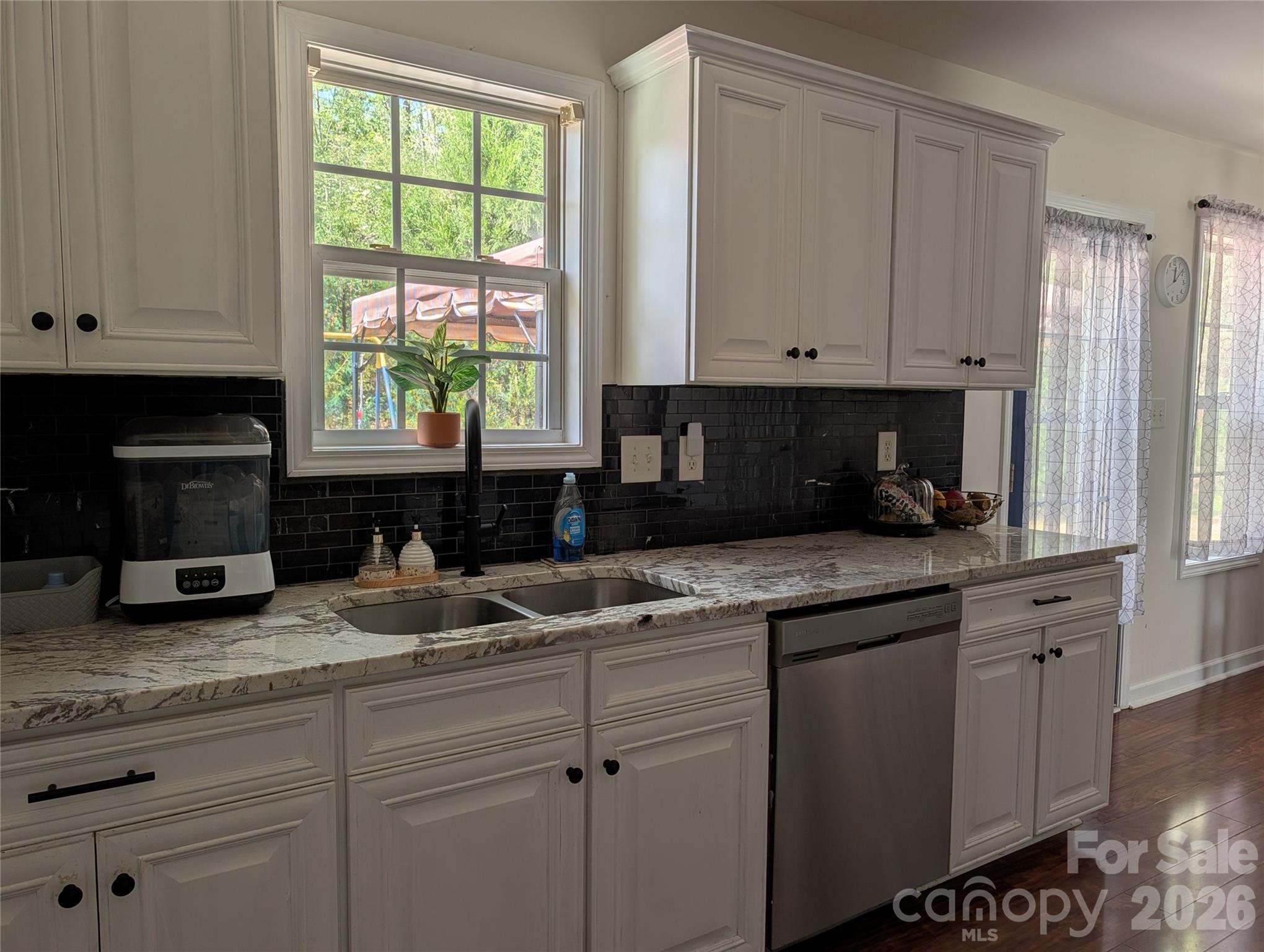 505 Azure Avenue Albemarle, NC 28001 - Photo 11 of 20 a kitchen with granite countertop white cabinets and window
