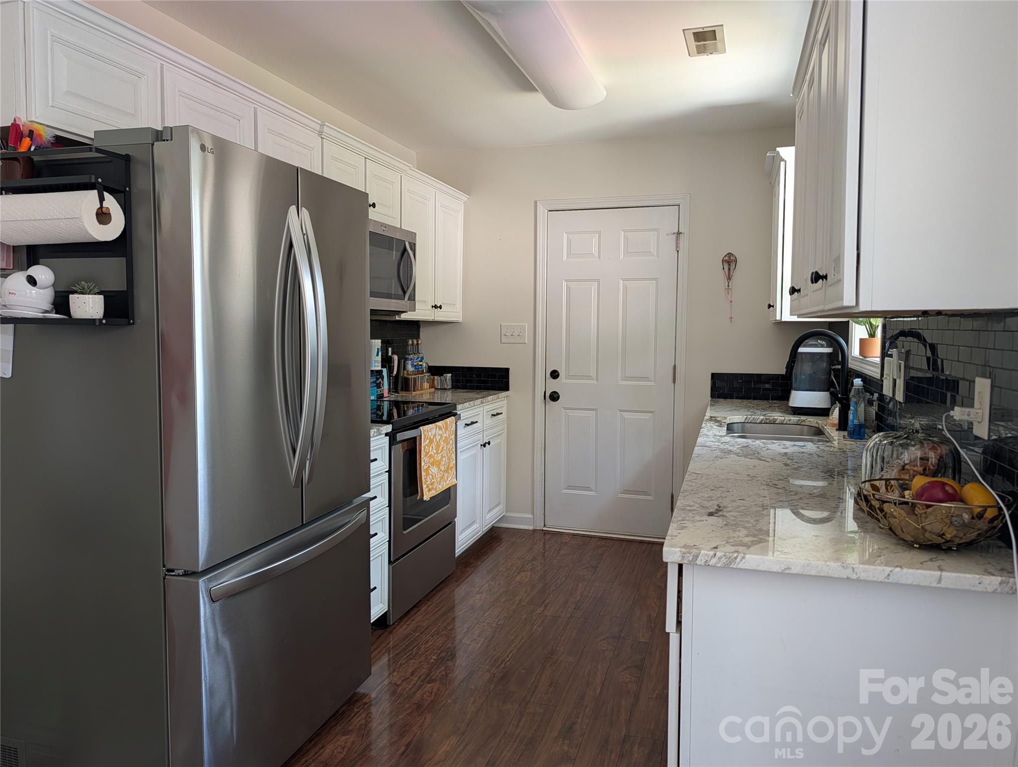 505 Azure Avenue Albemarle, NC 28001 - Photo 8 of 20 a kitchen with a refrigerator a sink and cabinets