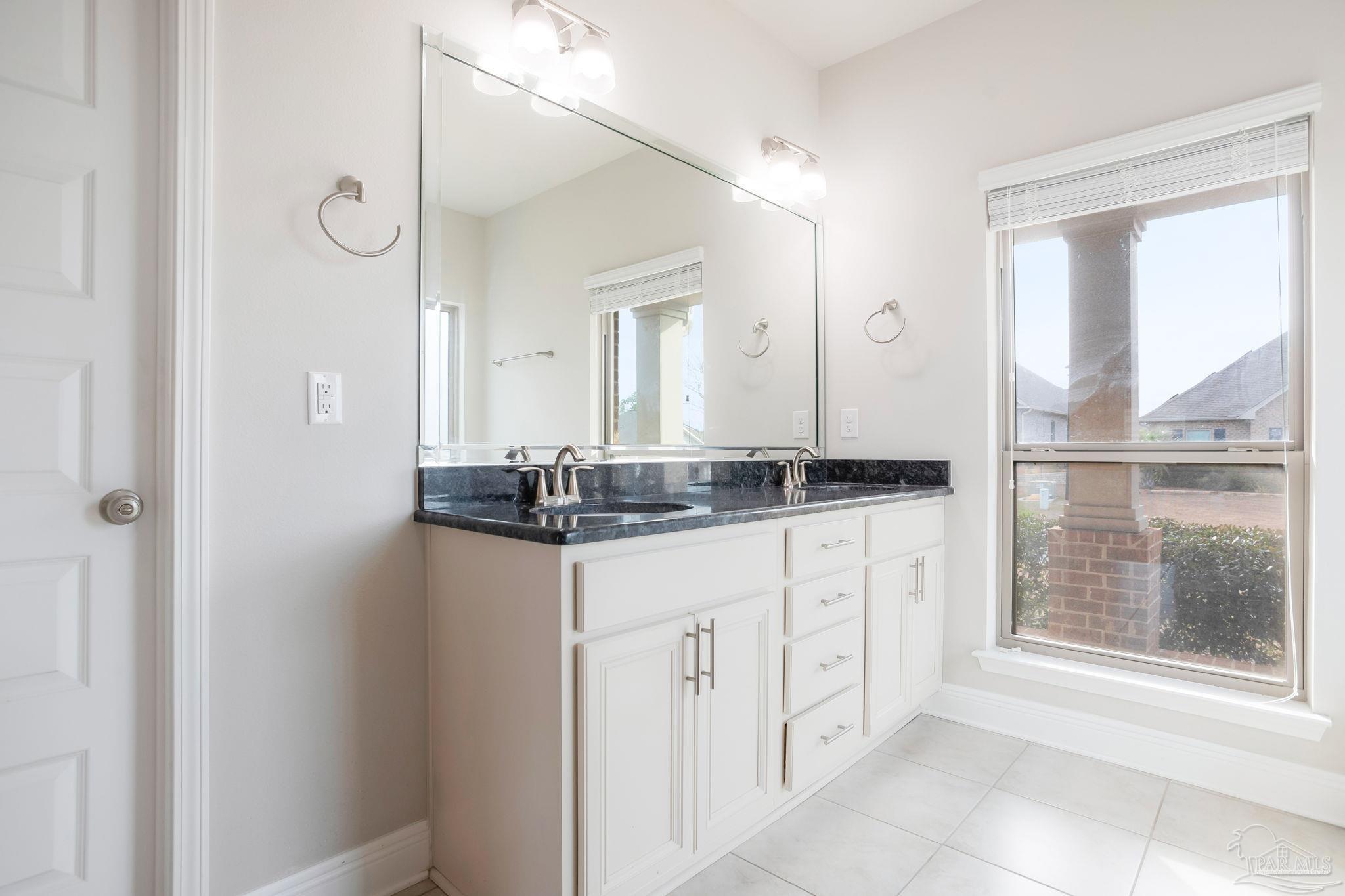 8016 Woodbrook Road Pensacola, FL 32526 - Photo 22 of 52 a bathroom with a granite countertop sink and a mirror