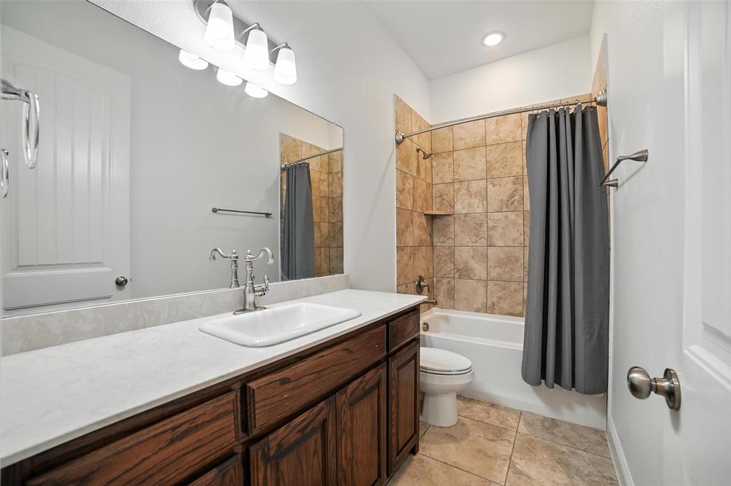 2616 Morning Mist Lane Nevada, TX 75173 - Photo 12 of 16 a bathroom with a sink a toilet a mirror and shower