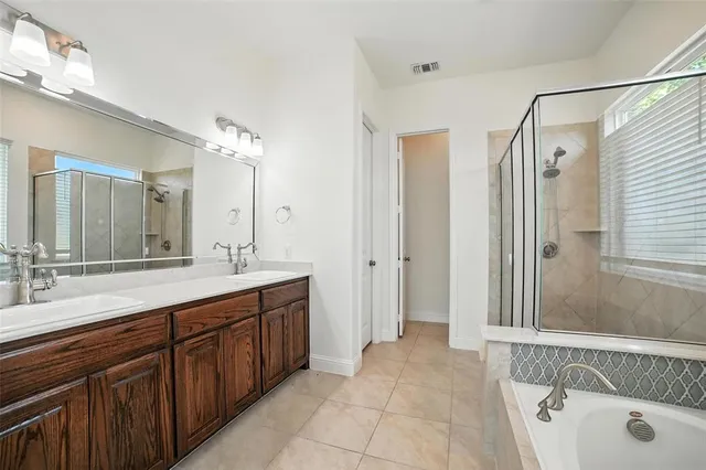 a spacious bathroom with a double vanity sink mirror double and shower