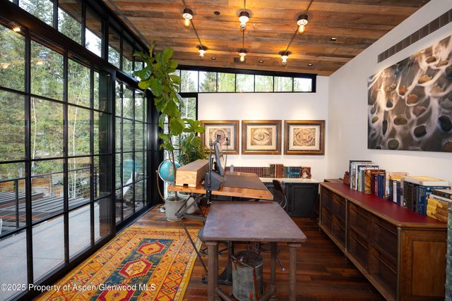 a room with lots of tables a chandelier and a couch