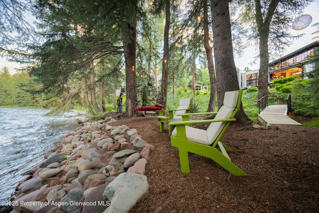 a view of a backyard with table and chairs