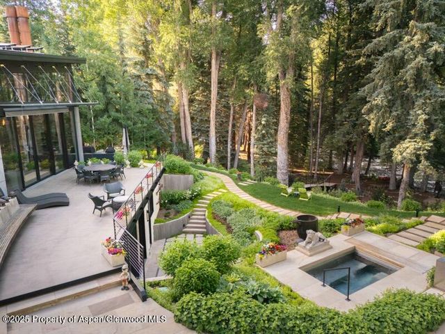 a view of backyard with swimming pool and patio