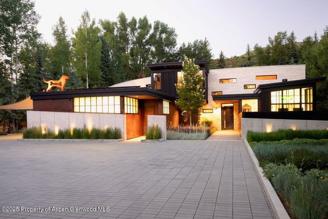 a front view of a house with a yard and a garage