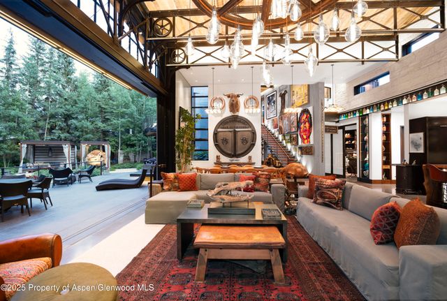 a living room with furniture a rug and a chandelier