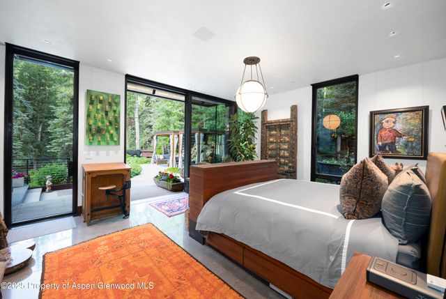 a bed room with a bed and a large window