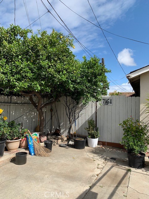7161 Main Street Westminster, CA 92683 - Photo 14 of 21 a view of backyard with a table and chairs and potted plants