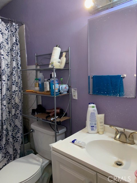 7161 Main Street Westminster, CA 92683 - Photo 20 of 21 a bathroom with a sink mirror vanity and toilet