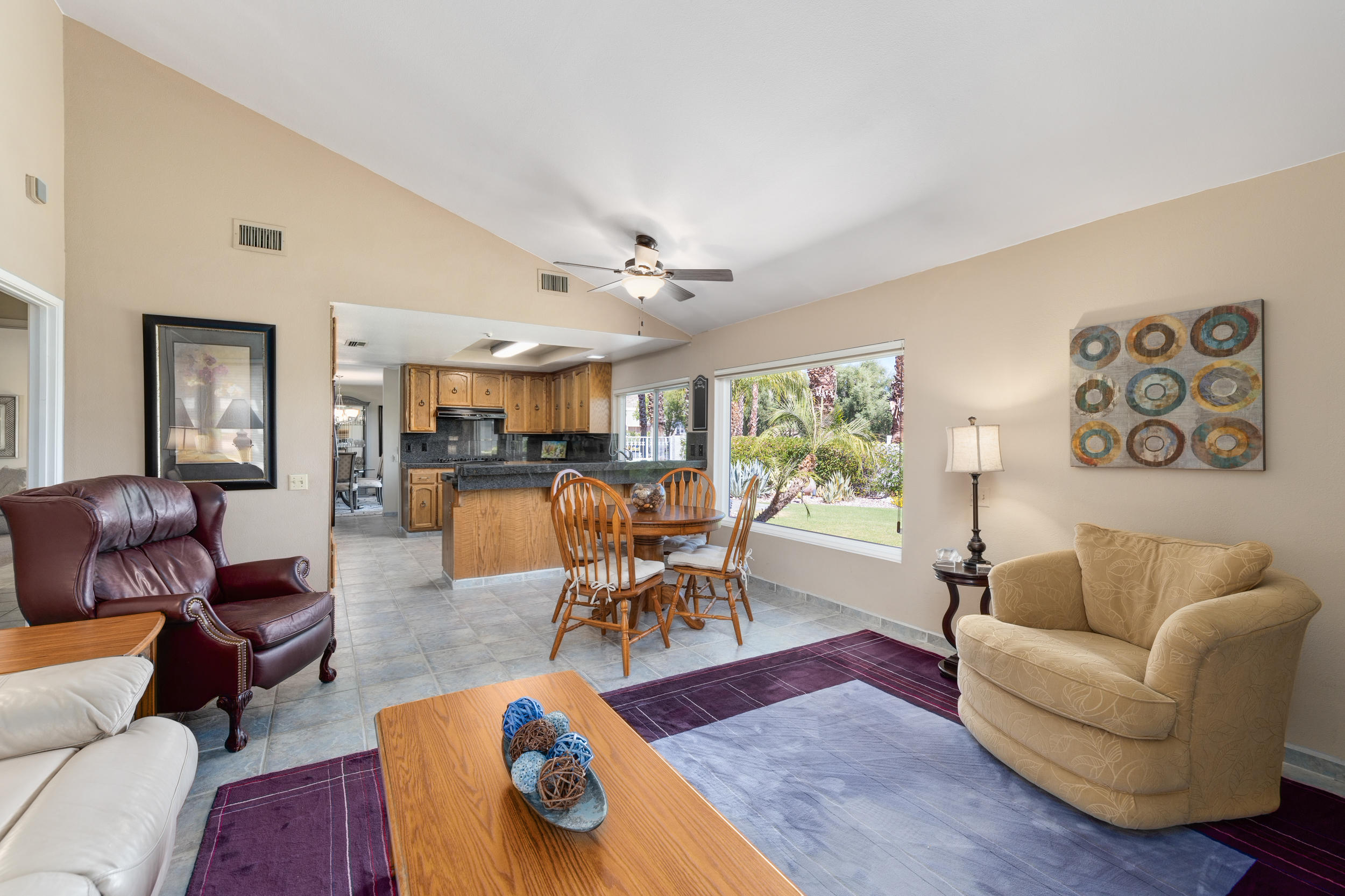 72733 Haystack Road Palm Desert, CA 92260 - Photo 14 of 60 a living room with furniture dining table a window and kitchen view