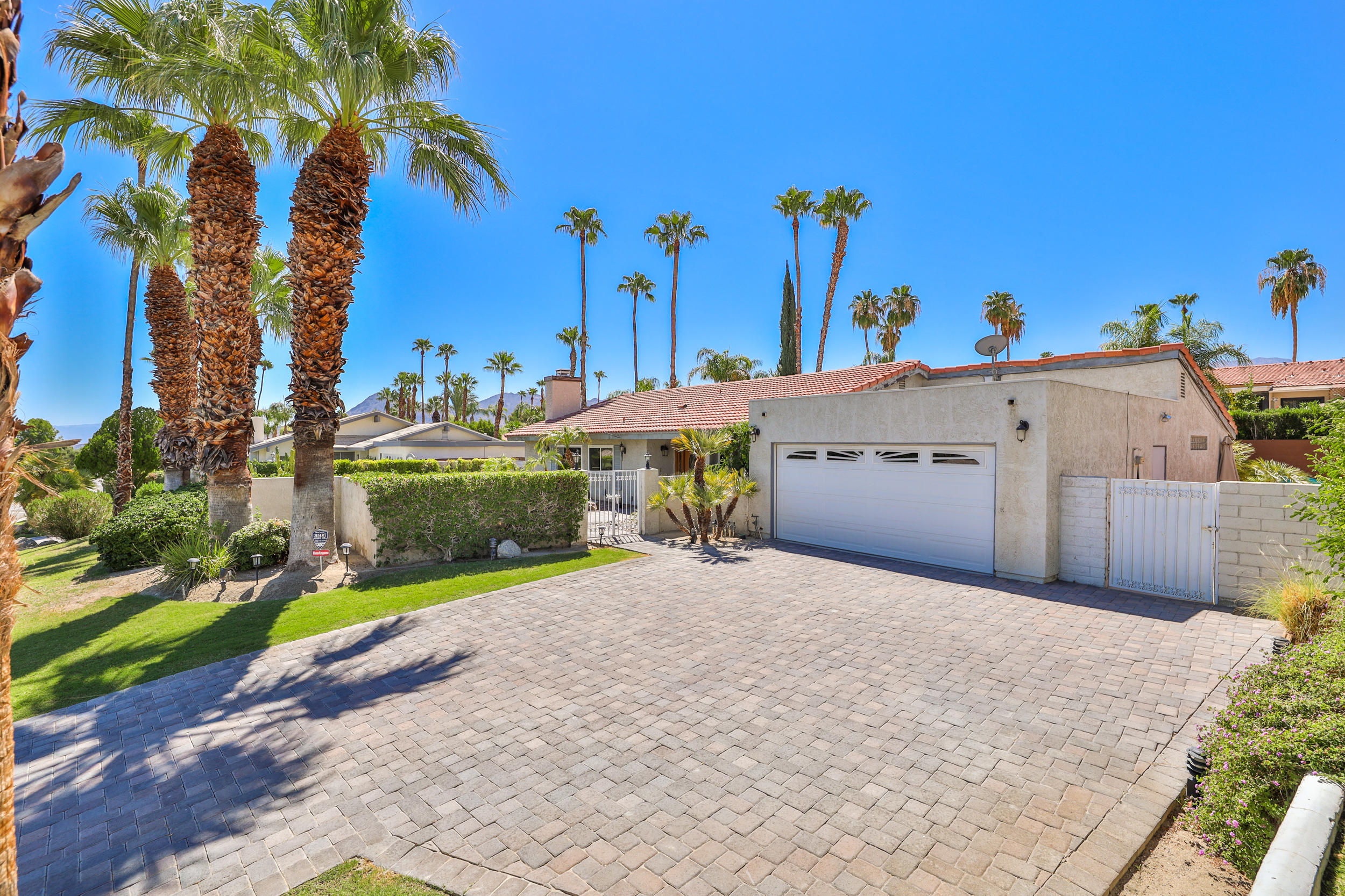 72733 Haystack Road Palm Desert, CA 92260 - Photo 50 of 60 a view of a house with a yard and potted plants