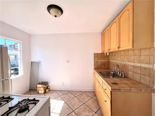 a kitchen with a sink a stove and cabinets