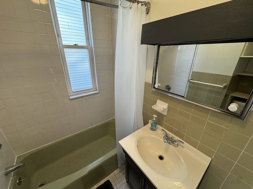 377 Highland Avenue, Unit 1 Somerville, MA 02144 - Photo 17 of 25 a bathroom with a sink and a bathtub