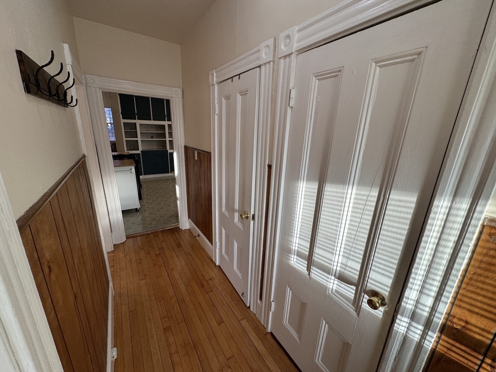 377 Highland Avenue, Unit 1 Somerville, MA 02144 - Photo 7 of 25 a view of walk in closet with wooden floor and stairs