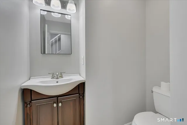 a bathroom with a sink toilet and mirror