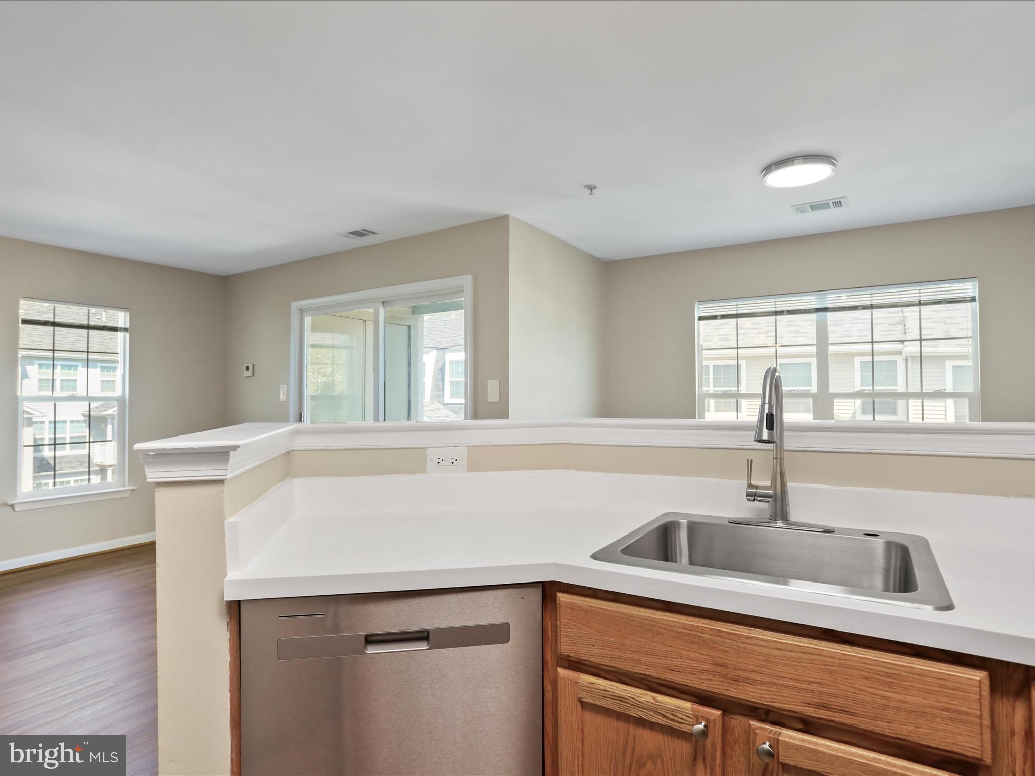 11312 King George Drive, Unit 4 Wheaton, MD 20902 - Photo 14 of 28 a kitchen with stainless steel appliances a sink a stove and a window