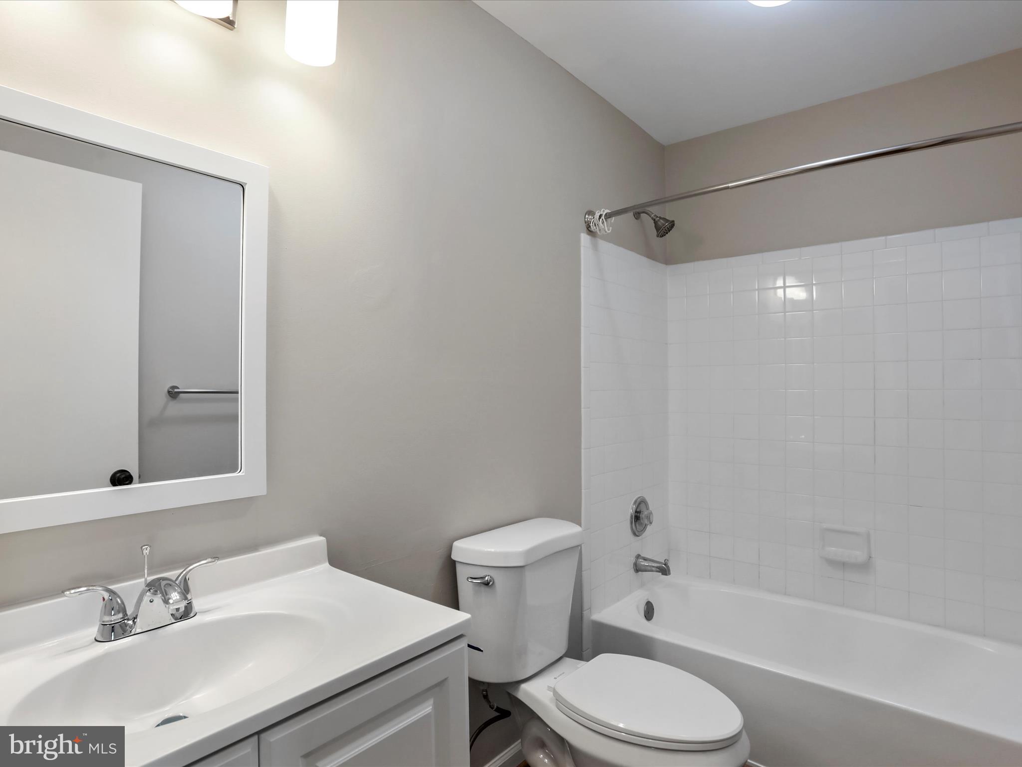 11312 King George Drive, Unit 4 Wheaton, MD 20902 - Photo 17 of 28 a bathroom with a sink toilet vanity and shower